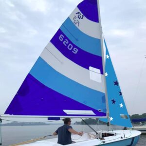 Dark blue, light blue and white Flying Scot sails with stars on the jib